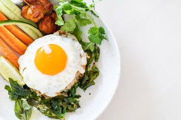 spicy fried rice with fried egg and vegetable