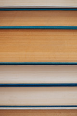 Vintage books close-up. Stack of used old literature in school library. Background from old chaotic reading matter. Dusty faded books horizontally with copy space. Old book store.