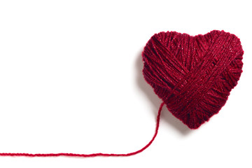 Handmade knitted red wool heart shape with copy space isolated on white 
