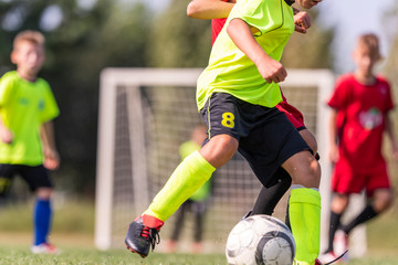 Young children players on the football match