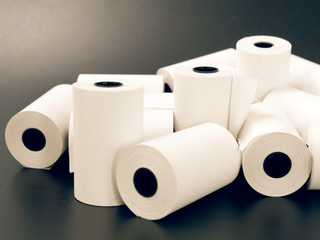 tape of white paper for cash on a black background.