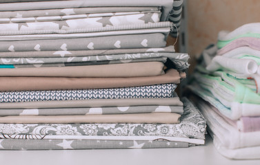 lots of bundles of different verities of new fabric in many color collections kept on the shelf of a local store in Asia