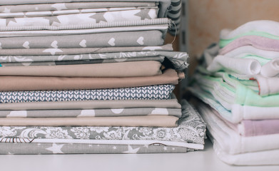 lots of bundles of different verities of new fabric in many color collections kept on the shelf of a local store in Asia