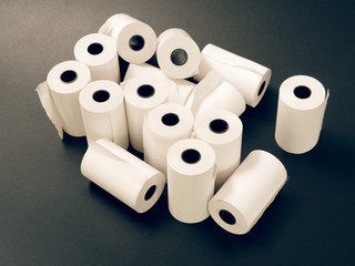 tape of white paper for cash on a black background.