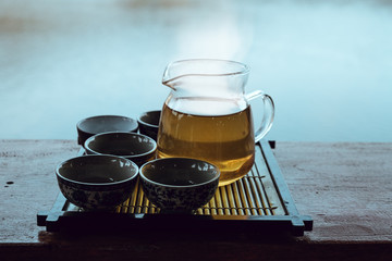 Pouring tea in glass cup,Vintage style