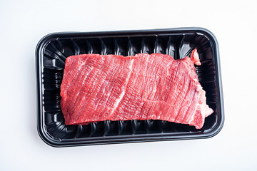 a box of fresh yellow beef on a white background