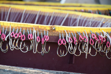 Long line fishing containers with hooks inside a boat - 248665611
