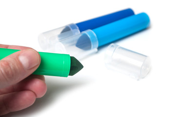 closeup of colorful felt pen in hand on white background