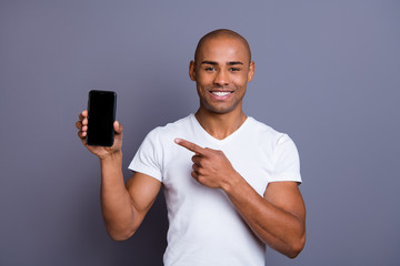 Close up photo strong healthy dark skin he him his macho bald head finger show new telephone...