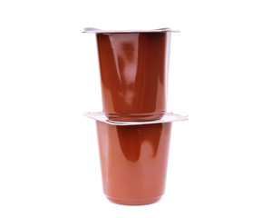Plastic cups with yogurt on white background