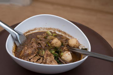 Thailand noodle in white chalice with a spoon and chopsticks
