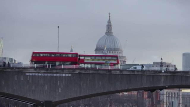 London Buses go past St Paul's Cathedral at dawn