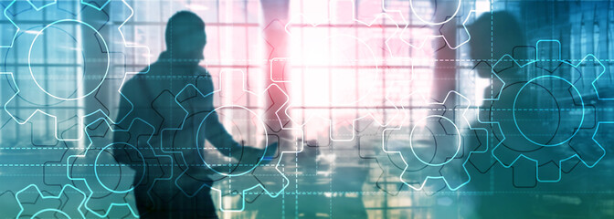 Double exposure gears mechanism on blurred background. Business and industrial process automation concept.