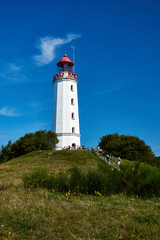 Fototapeta na wymiar postcard lighthouse on isle of Hiddensee in summer