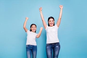 Close up photo cheer two people brown haired mum small little daughter  hands arms high in air glad...