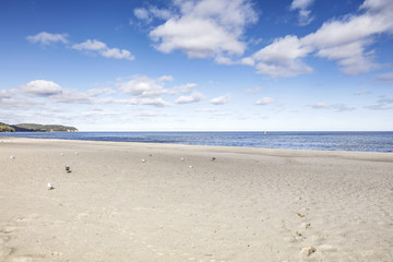 Fototapeta na wymiar Beach of sand and sea landscape with blue sky and clouds 