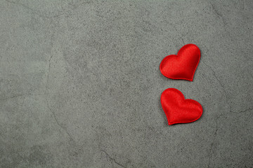 Fototapeta premium Valentines day background with red hearts on old concrete table. - Love and care concept.