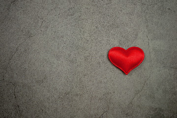 Valentines day background with red hearts on old concrete table. - Love and care concept.