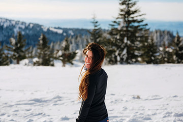 Fototapeta na wymiar beautiful girl on snow smile in camera