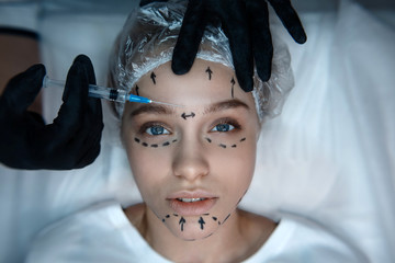 Calm peaceful nice young woman lying on couch and look straight. Her skin is marked. Beautician...
