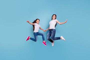 Fototapeta na wymiar Full length body size view of two nice cute free lovely attractive cheerful cheery slim sporty people in white t-shirt holding hands having fun isolated over blue pastel background