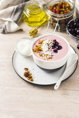Granola smoothie bowl with frozen berries. Selective focus, space for text.