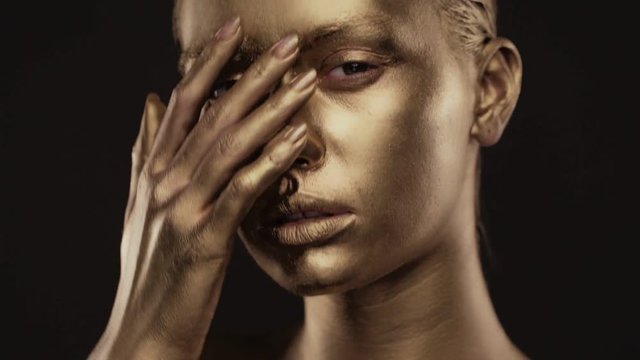 Beautyful girl with gold glitter on her face.Art image beauty face.