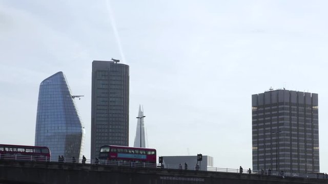 London Buses Pass the City skyline at sunrise