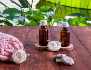 Aromatherapy oils, small stones, pink towel