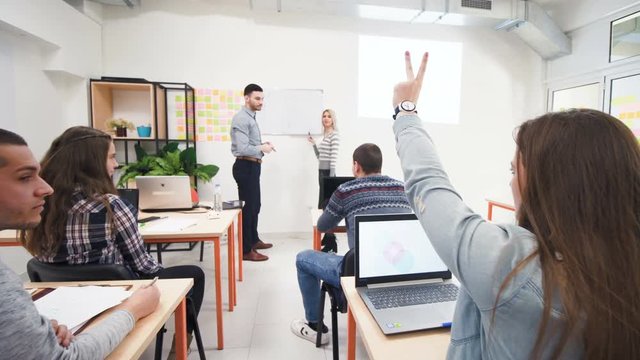 students interacting with professor in a classroom