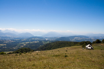 Fototapeta na wymiar Altitude Panorama over Annecy Lake and French Haute Savoie Valley with Barn on a Sunny Summer Day