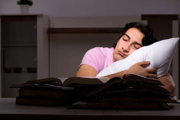 Fototapeta premium Male handsome student preparing for exams late at home