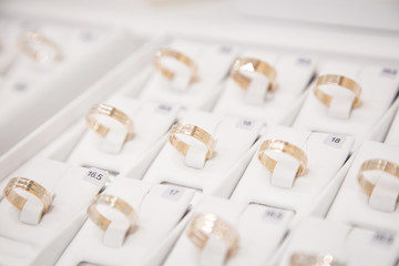 Jewelry, golden rings in jewelry shop, close-up. Golden rings in the box