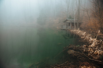 gazebo on a lake in a misty forest