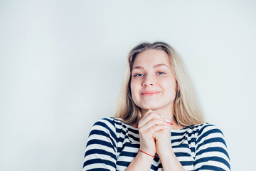 Portrait of beautiful smiling blonde woman in striped dress on white background
