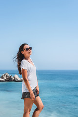 Young pan asian brunette girl with long hair enjoying great view of the sea