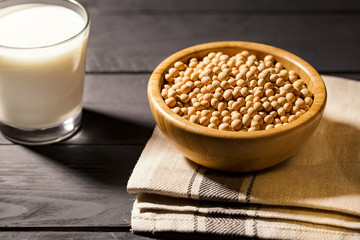 Healthy glass of soymilk and soyseeds in a bowl.