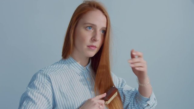 gingerhead red hair, ginger hair model comb her straight shiny hair
