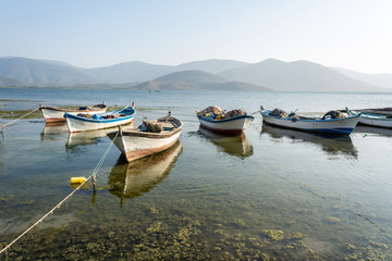 Fishing boats moored along the shore of Lake Bafa in Turkey.