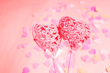 Closeup of two pink hearts on a blue background, selective focus