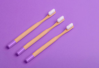 Flat lay composition with bamboo toothbrush space for text on color background