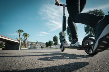 Woman on an electric scooter on the road.