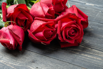 Bouquet of red rose flower on dark wooden table. Can use for valentine day concept or background.