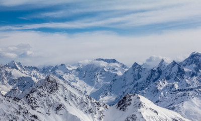 Snowy Mountains in blue and white sky