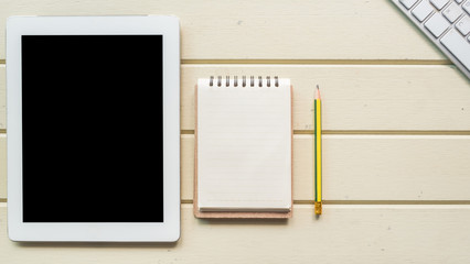 Working space, taplet and notebook on white wooden desk