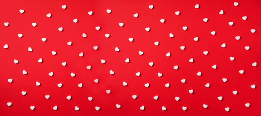 Seamless pattern. White hearts on red background. Top view. Valentine's Day. Love, date, romantic concept. Banner