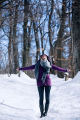 Fototapeta na wymiar woman walking in snowy forest