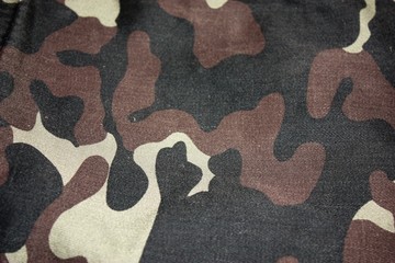 Texture of fabric with a camouflage painted in colors of the marsh. Army background image. Textile pattern of military camouflage fabric