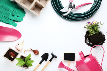 Garden tools with flowers on white background