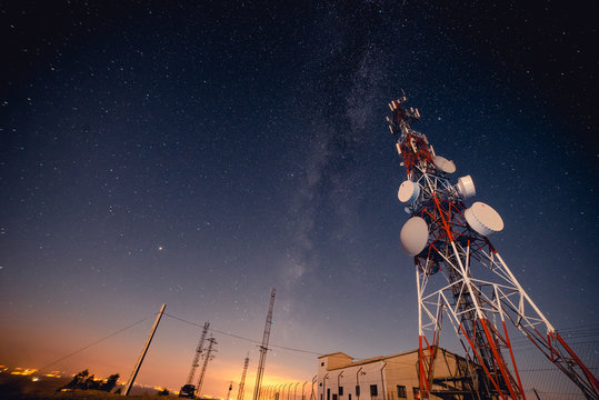 From below tall modern radio tower located against majestic starry sky at wonderful night